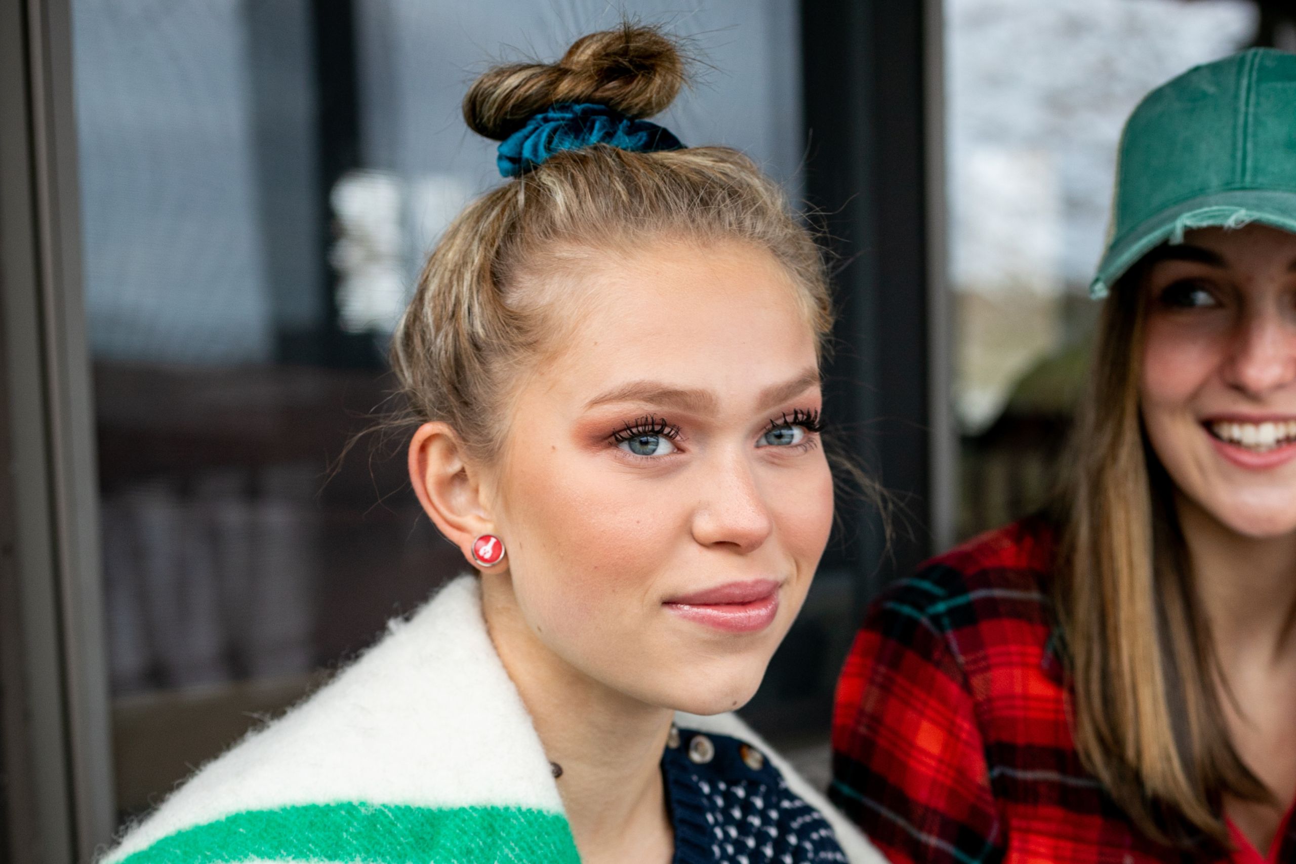 Headshot of a girl showing off Erin flett earings and a blanket