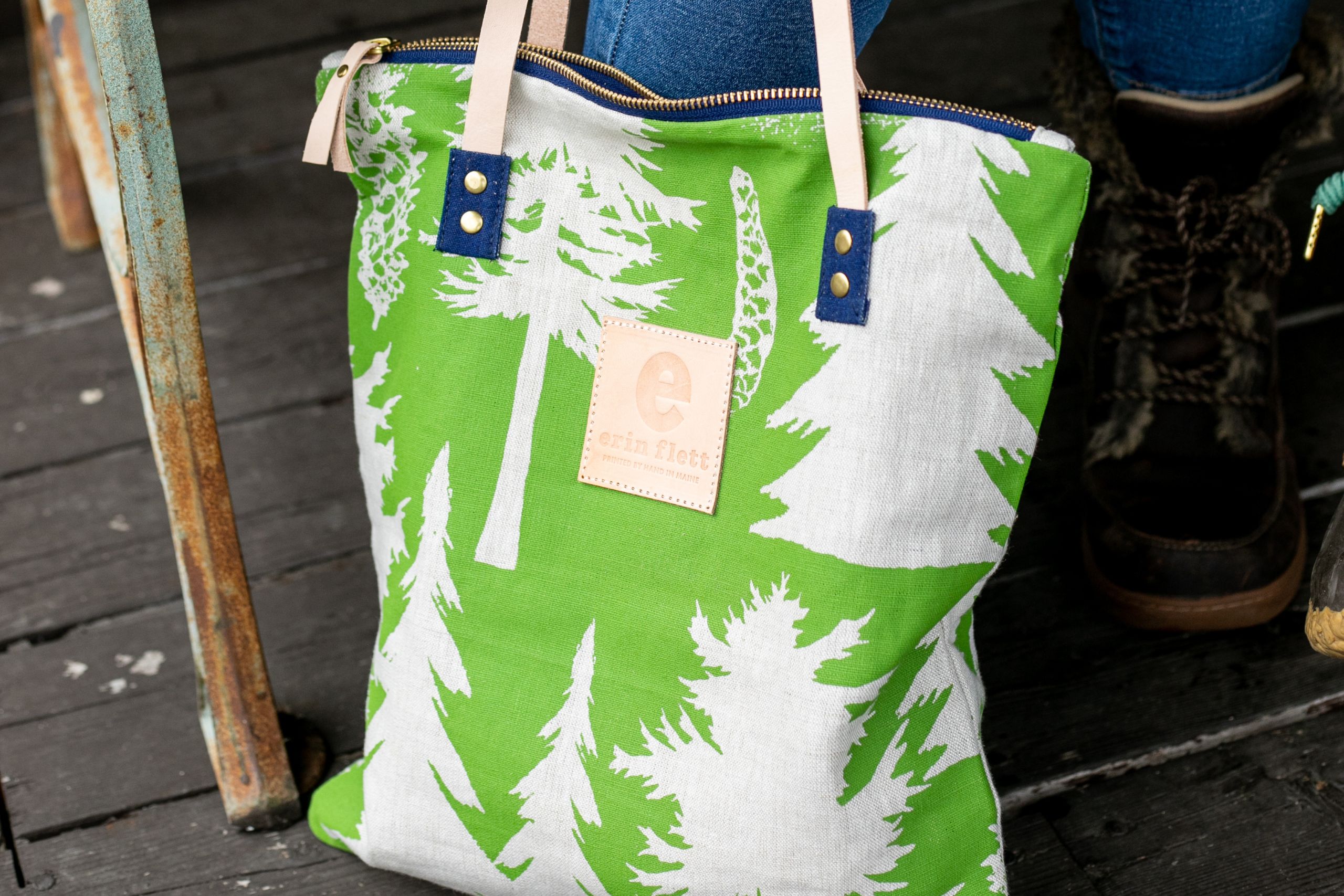 A photo of a green erin flett bag. It features a tree design.