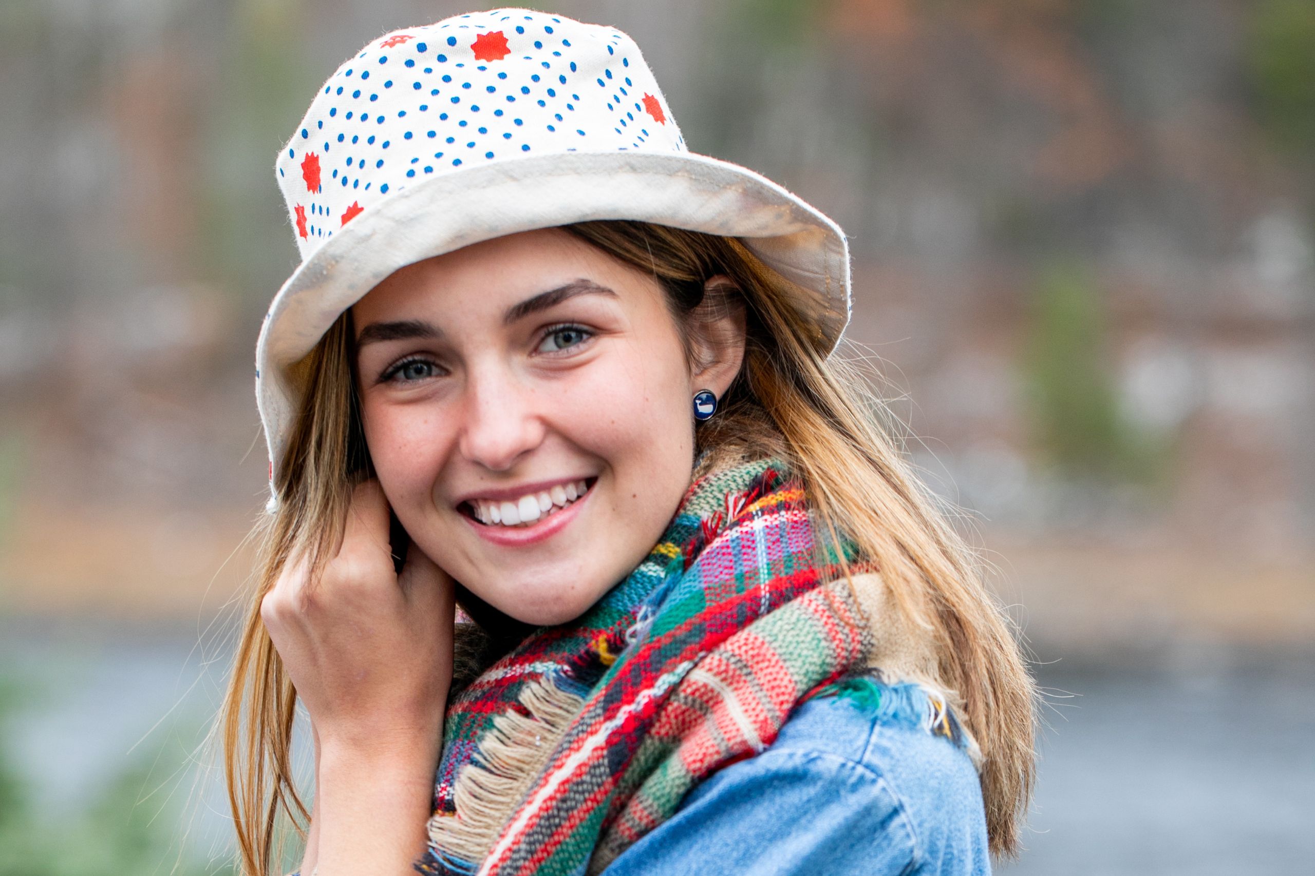 A woman poses for the camera while wearing a bucket hat
