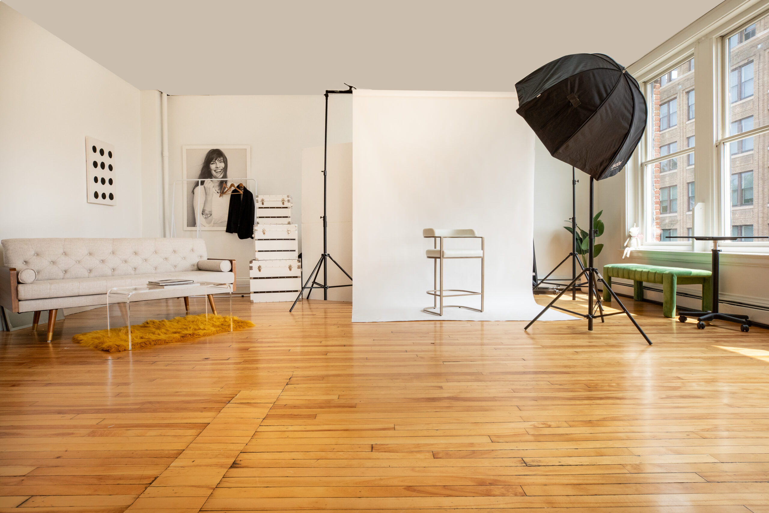 White studio loft photo shoot with hardwood floors and natural light.